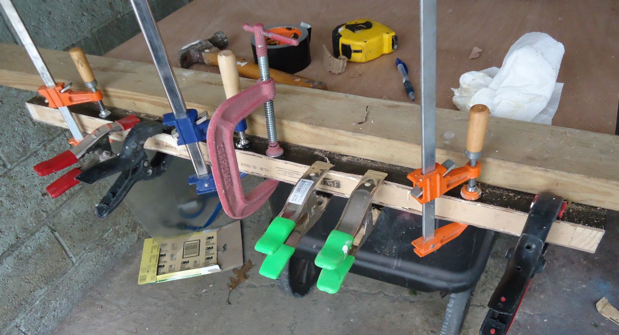 Clamps holding a glued wooden piece in place