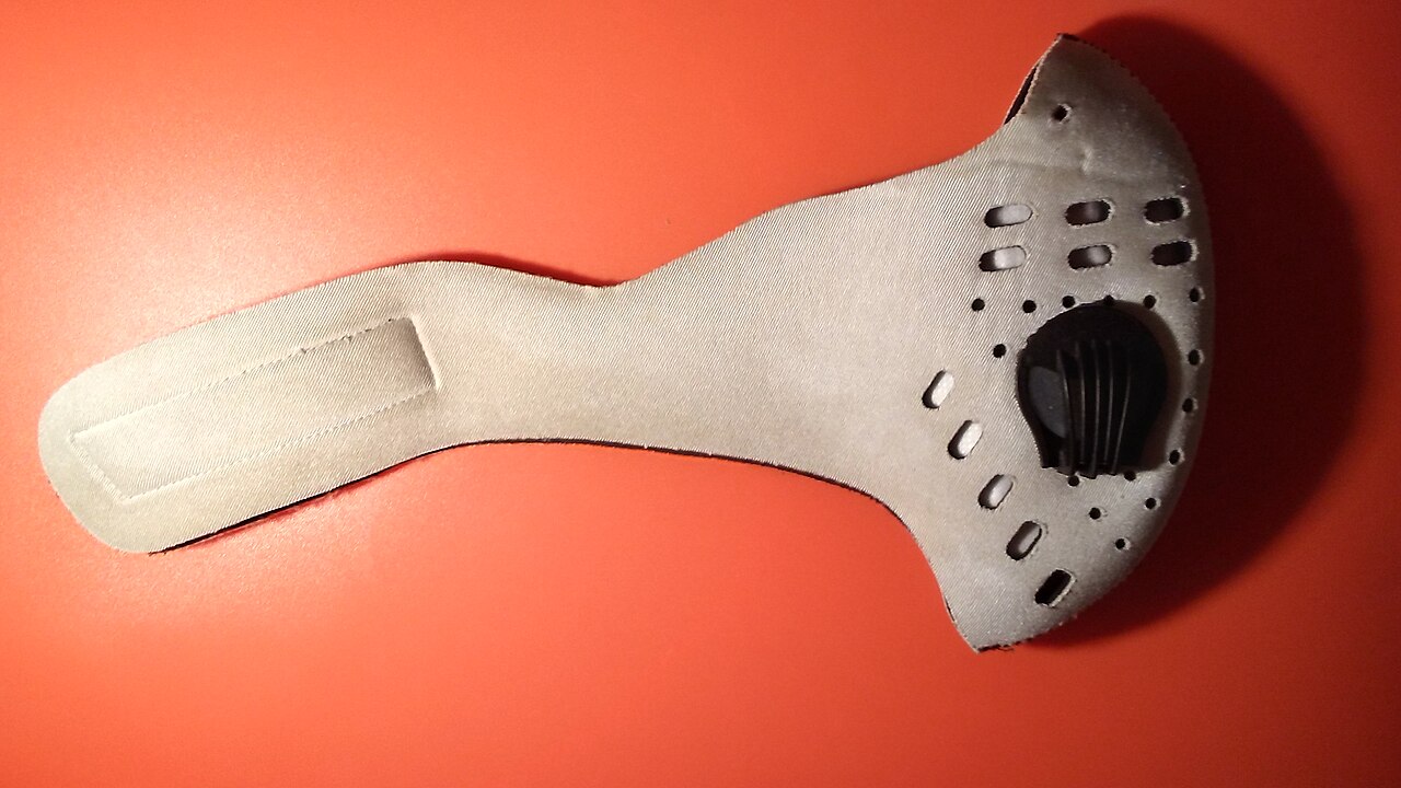 A protective dust mask on a plain surface