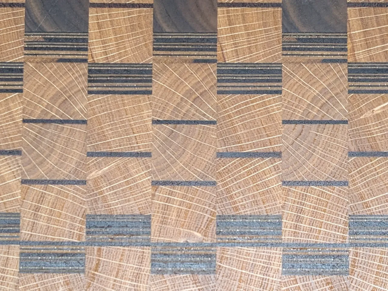 A close-up of walnut end grain cutting board